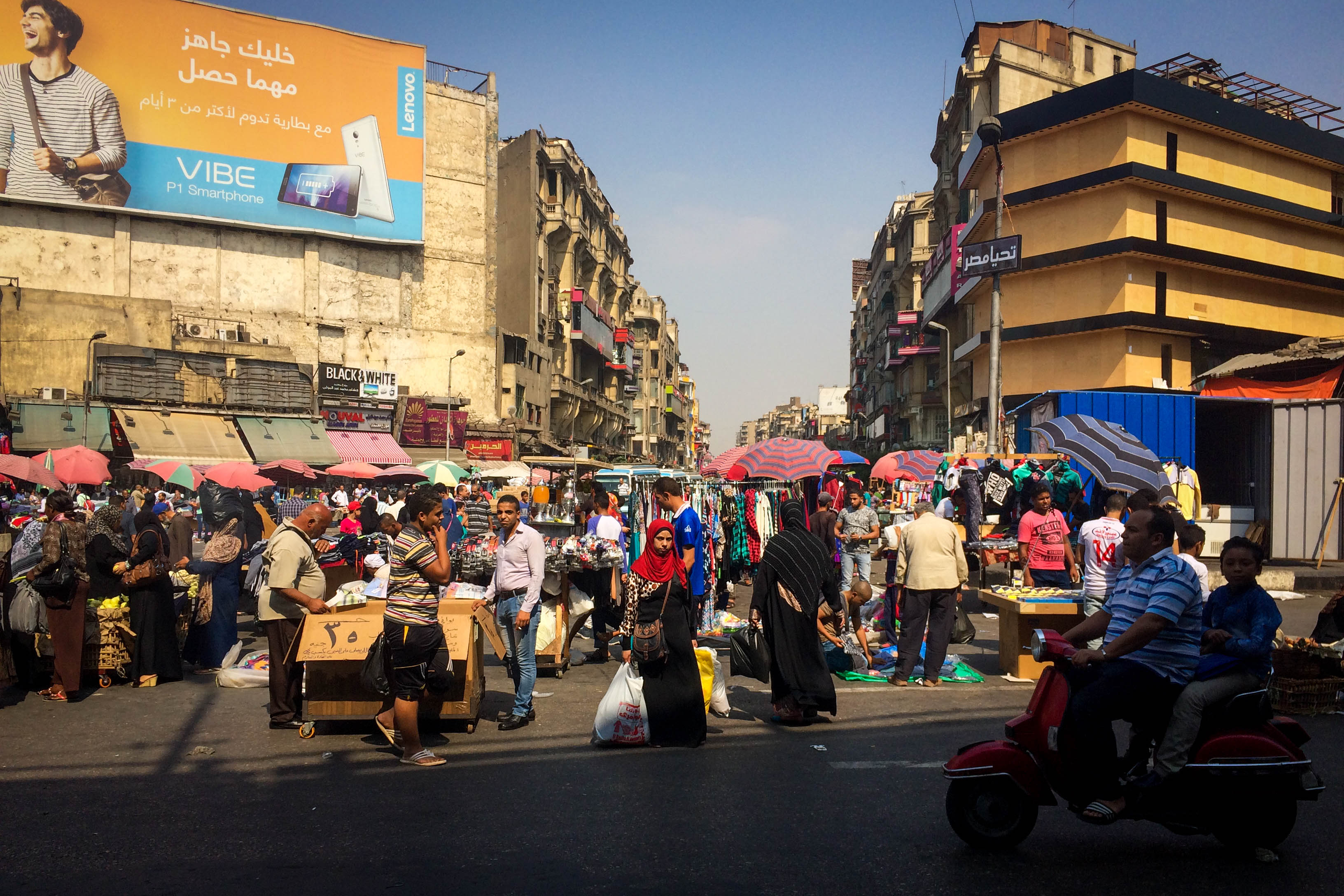 Wallpaper People in a Street With Cars Parked on The Side During ...