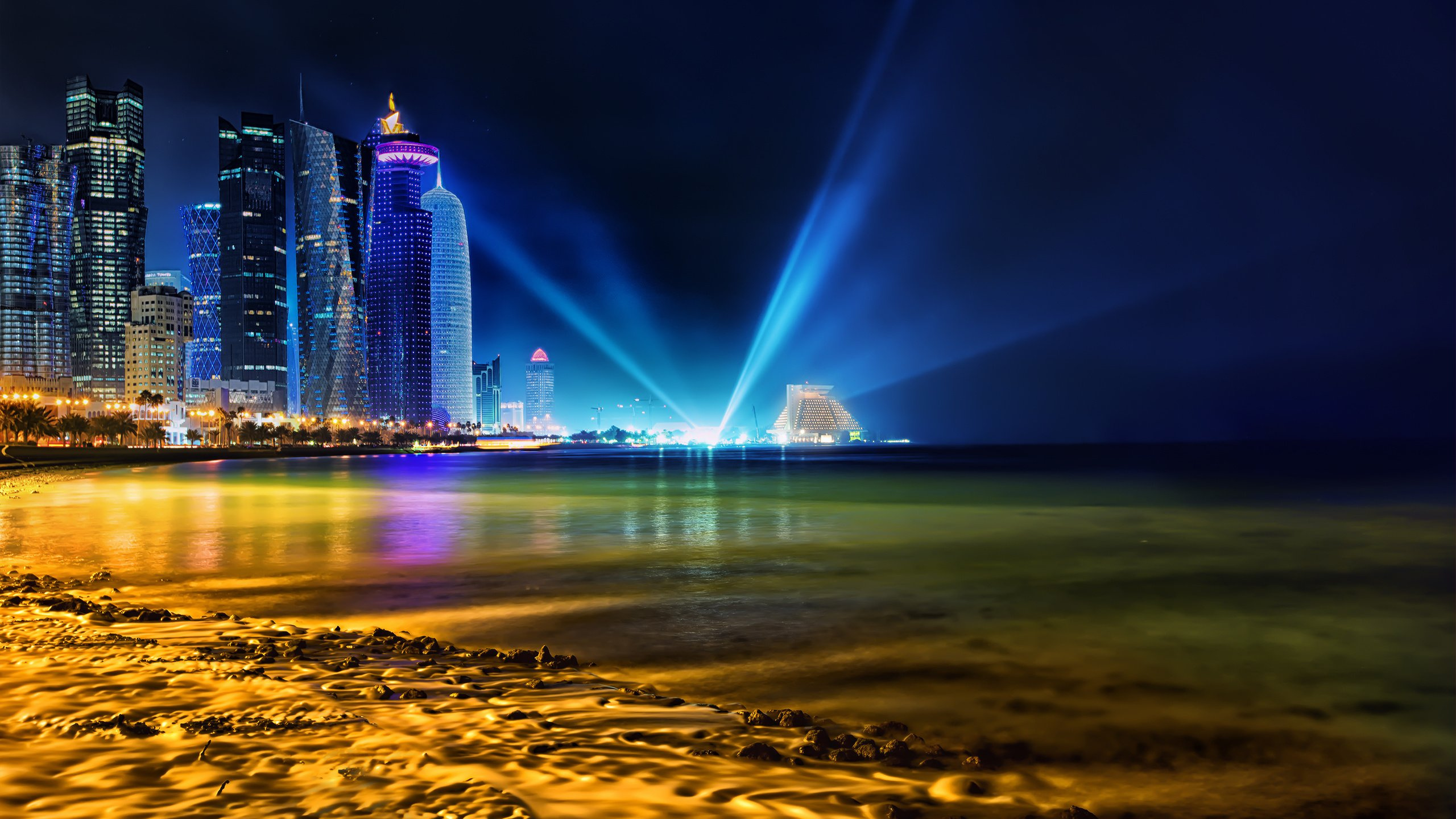 City Skyline Across Body of Water During Night Time. Wallpaper in 2560x1440 Resolution