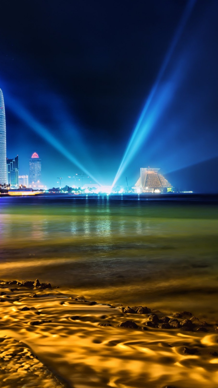 City Skyline Across Body of Water During Night Time. Wallpaper in 720x1280 Resolution