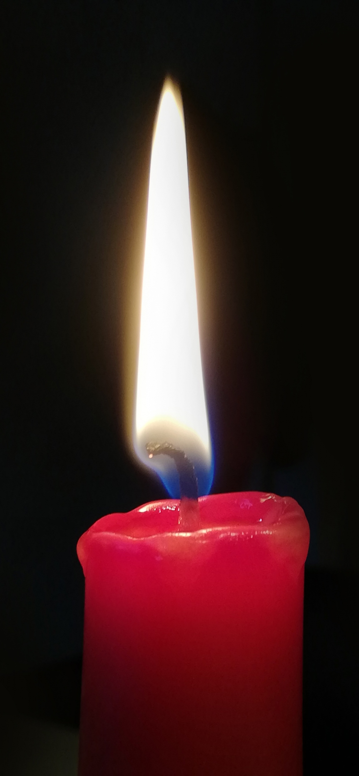 Red Pillar Candle With Black Background. Wallpaper in 1242x2688 Resolution