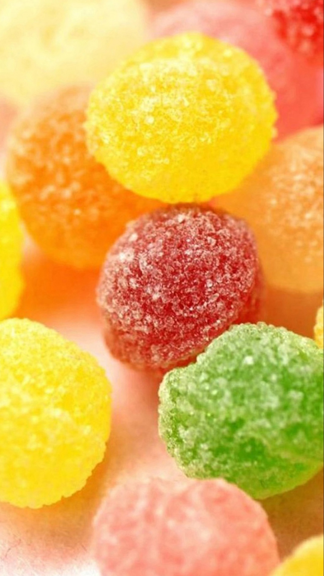 Gelbe Rosa Grüne Und Orange Bonbons. Wallpaper in 1080x1920 Resolution