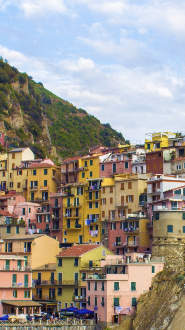 Brown and White Concrete Houses on Mountain During Daytime. Wallpaper in 720x1280 Resolution