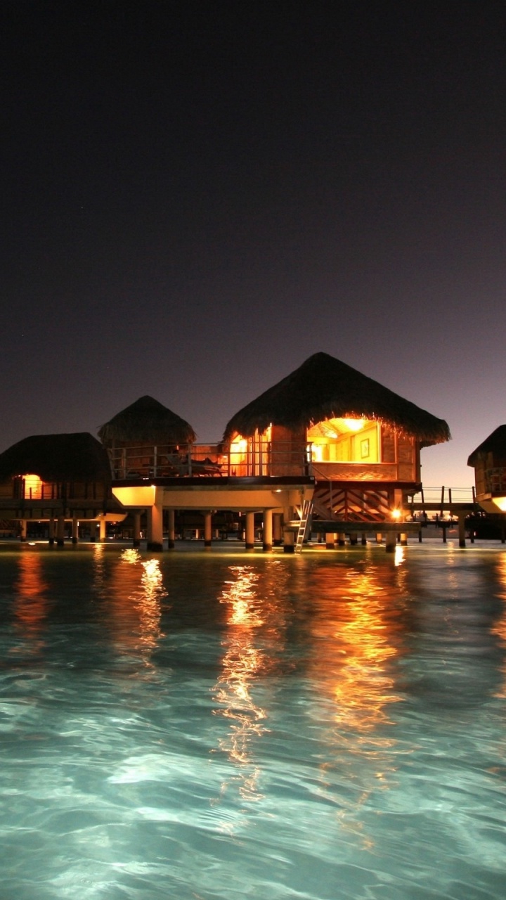 Brown and Green Wooden House on Water During Night Time. Wallpaper in 720x1280 Resolution