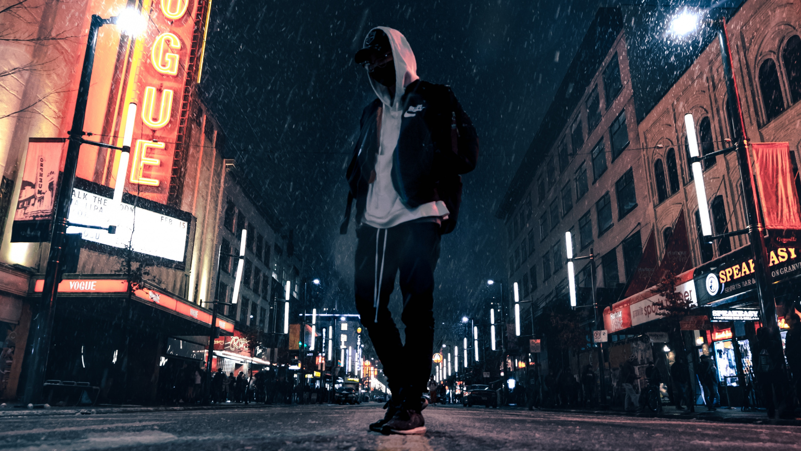Man in White Shirt and Black Pants Walking on Street During Night Time. Wallpaper in 2560x1440 Resolution