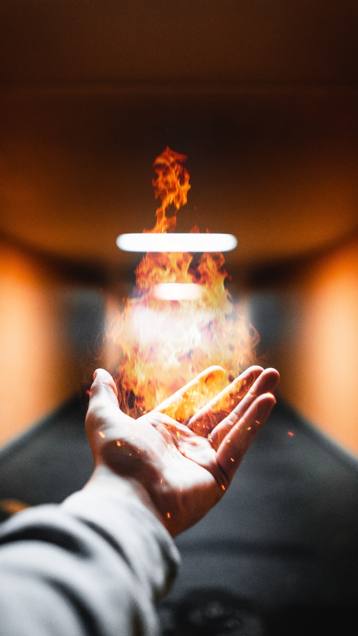 Person Holding Fire During Night Time. Wallpaper in 720x1280 Resolution