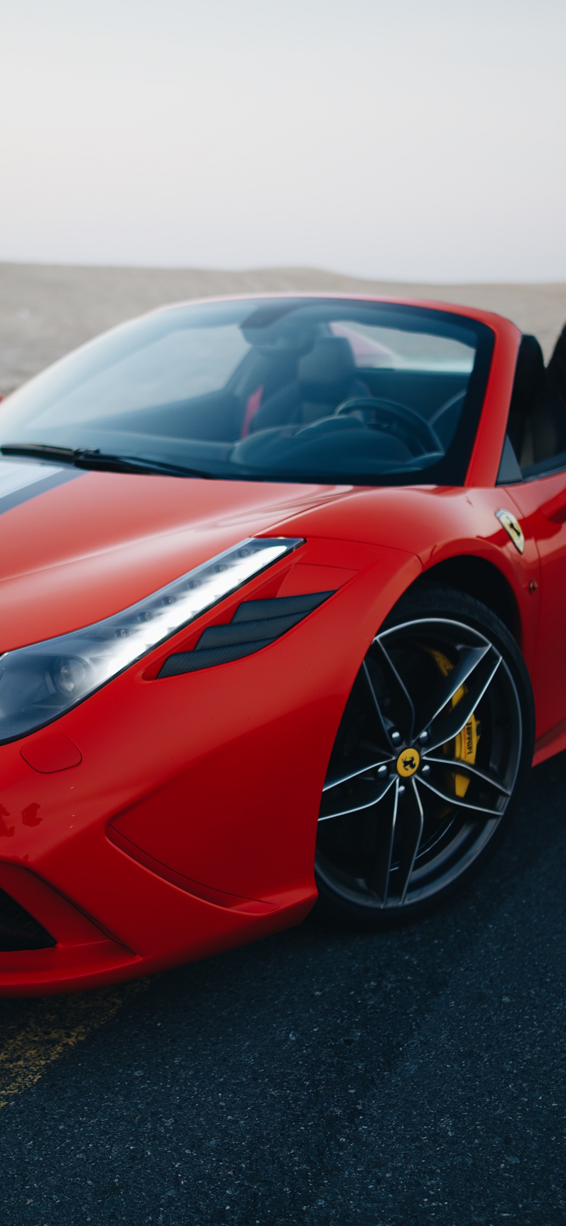 Red Ferrari Sports Car on Black Asphalt Road During Daytime. Wallpaper in 1125x2436 Resolution