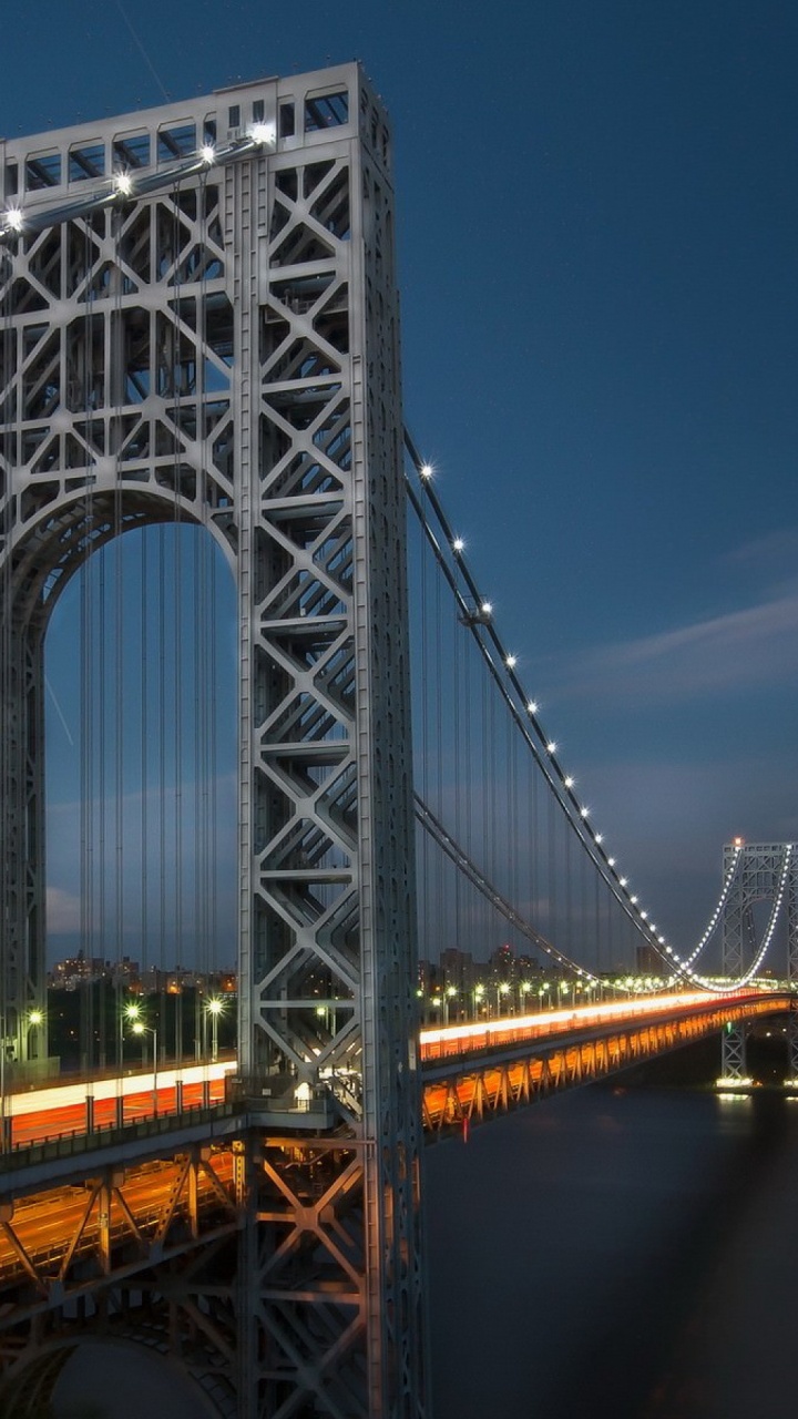 Gray Bridge Over Body of Water During Night Time. Wallpaper in 720x1280 Resolution