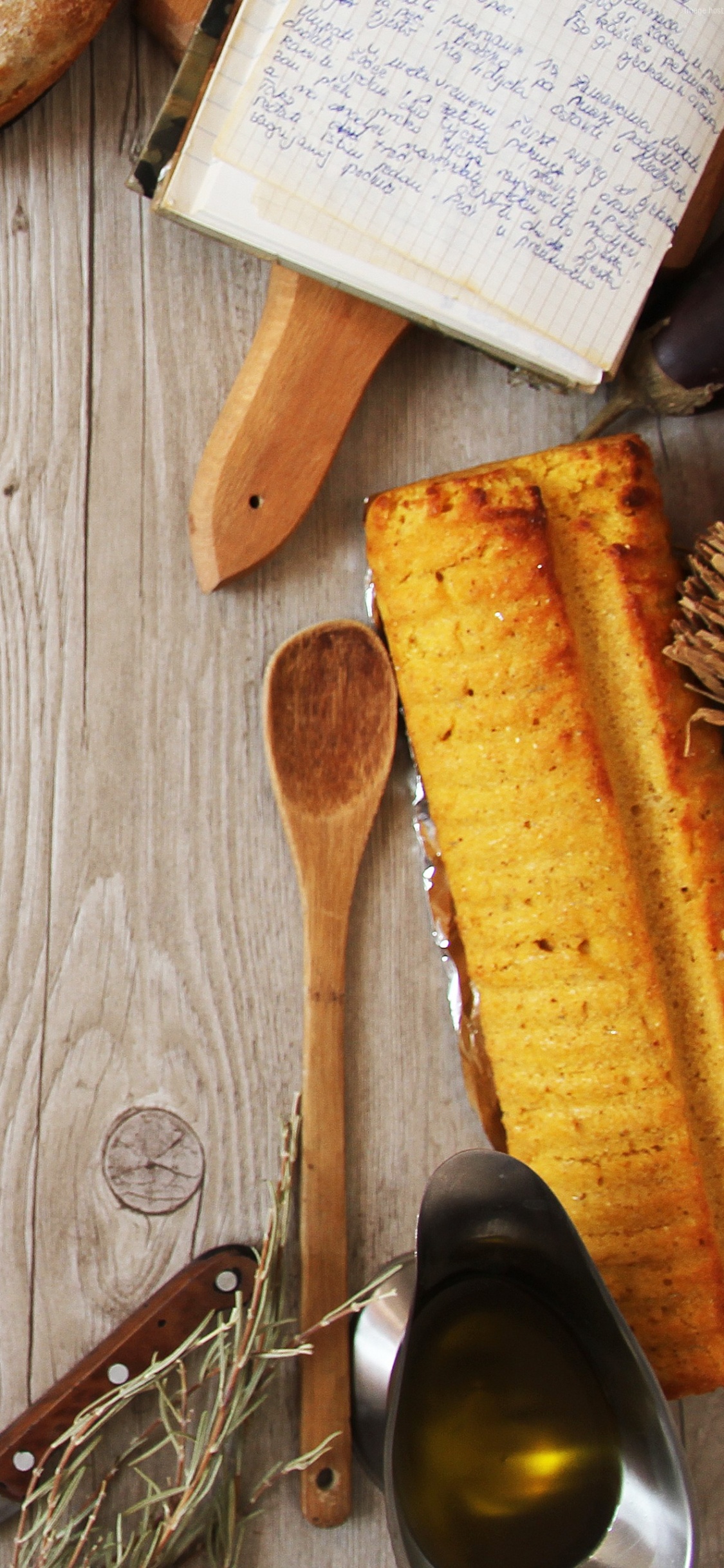 Sliced Bread on White and Blue Floral Ceramic Plate Beside Brown Wooden Ladle. Wallpaper in 1125x2436 Resolution