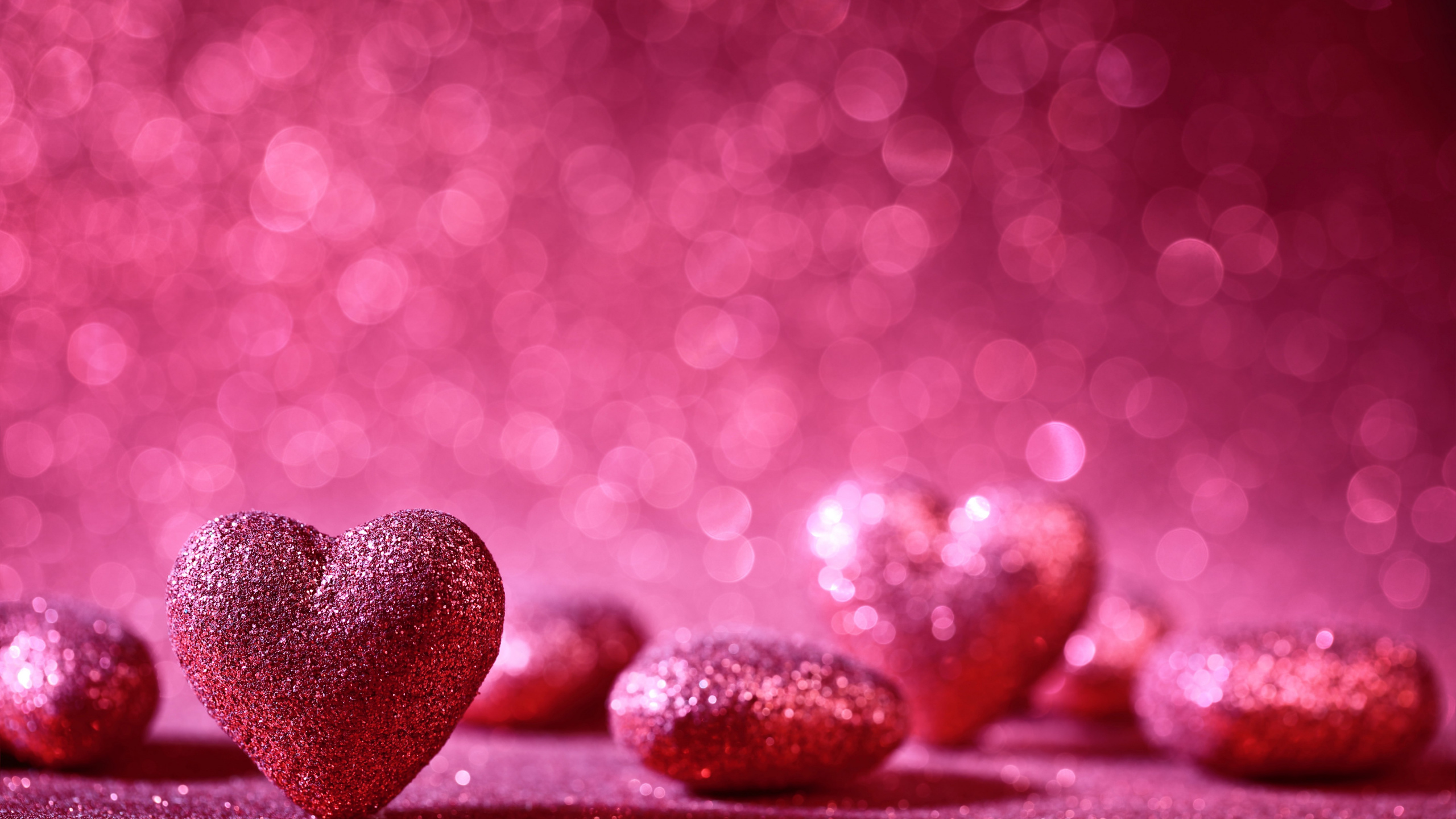 Black and Red Heart Shaped Stones on Red Surface. Wallpaper in 2560x1440 Resolution