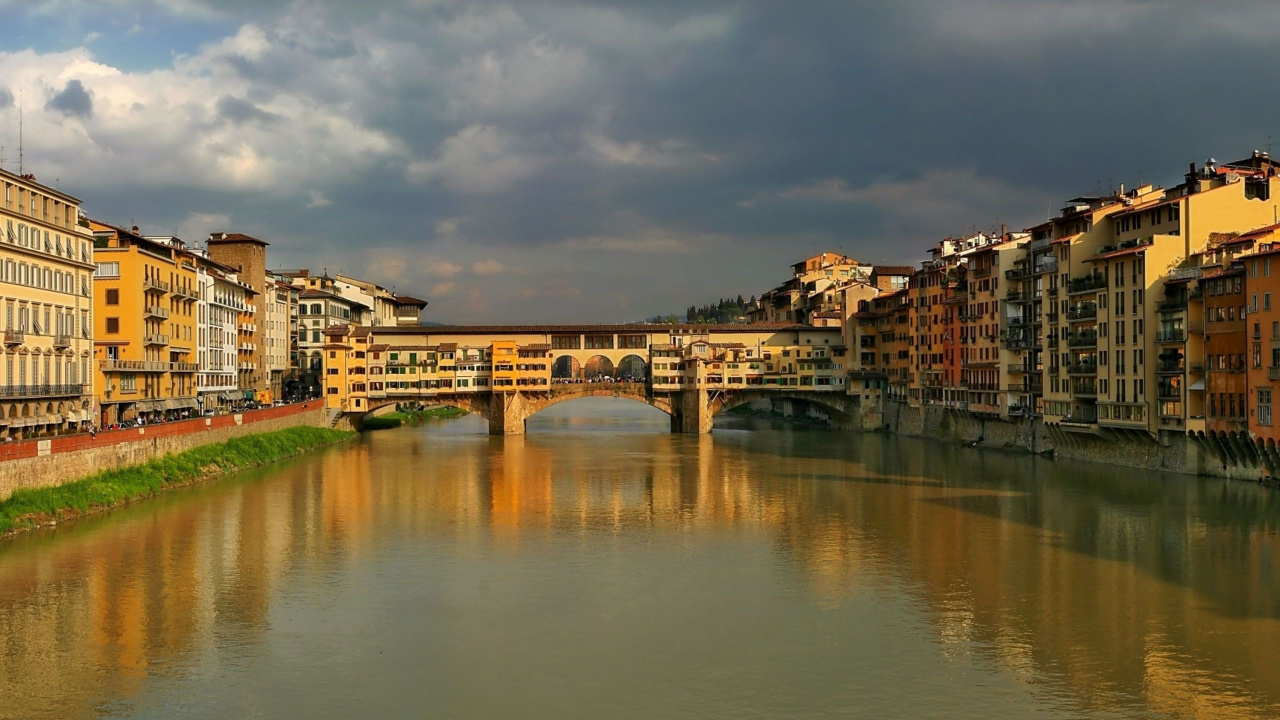 Brown Concrete Building Near River Under Cloudy Sky During Daytime. Wallpaper in 1280x720 Resolution