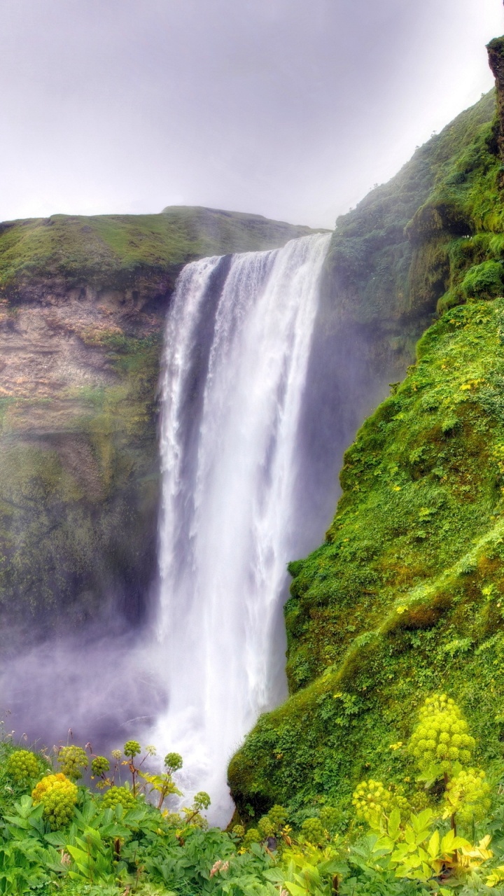 Waterfalls on Green Moss Covered Mountain Under Gray Cloudy Sky. Wallpaper in 720x1280 Resolution