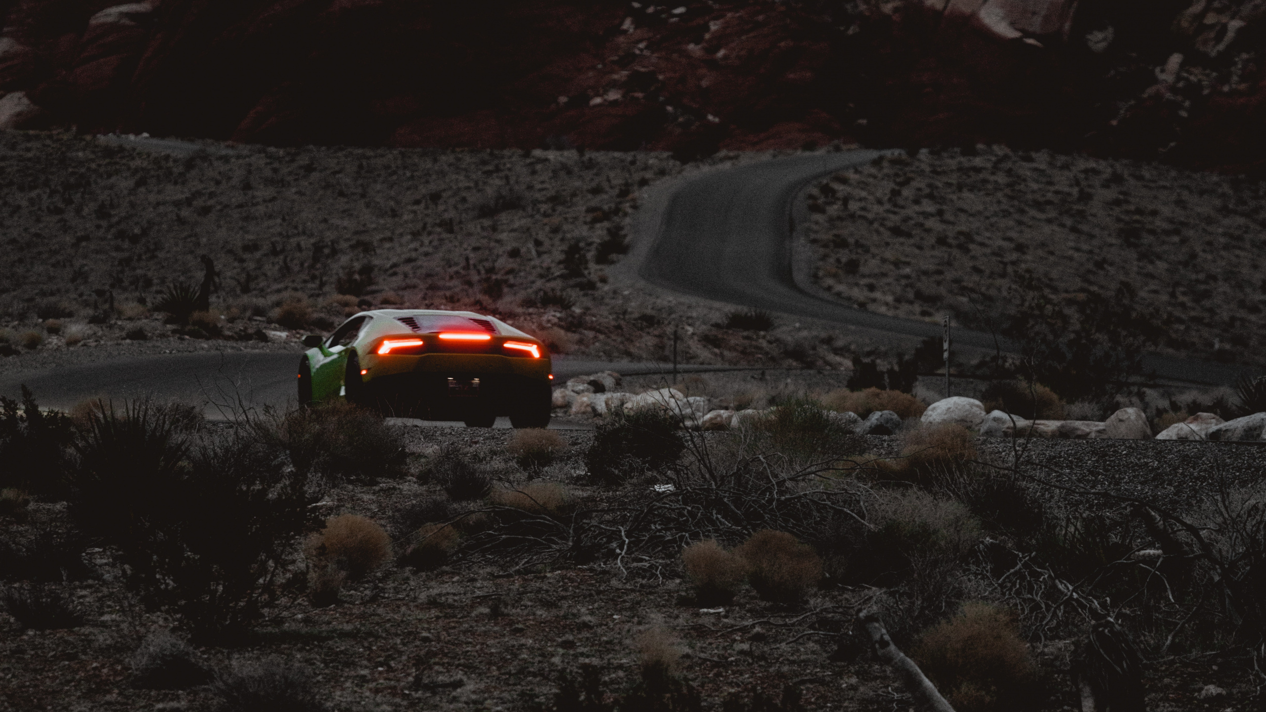 Red Car on Road Near Rocky Mountain During Daytime. Wallpaper in 2560x1440 Resolution