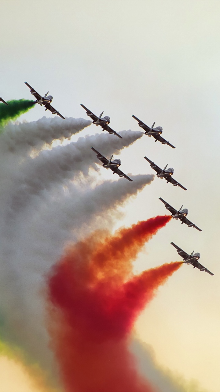 Five Black Birds Flying Over Green White and Red Smoke. Wallpaper in 720x1280 Resolution