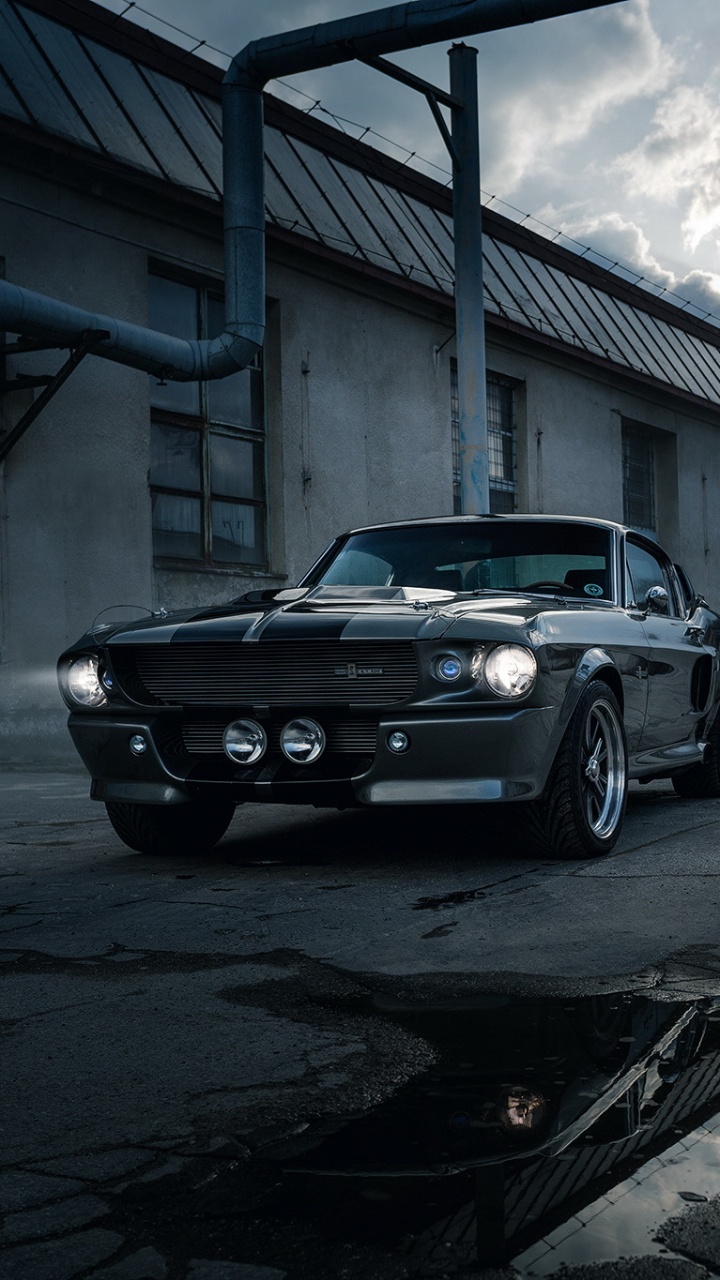 Black Sedan Parked on Gray Concrete Road During Daytime. Wallpaper in 720x1280 Resolution