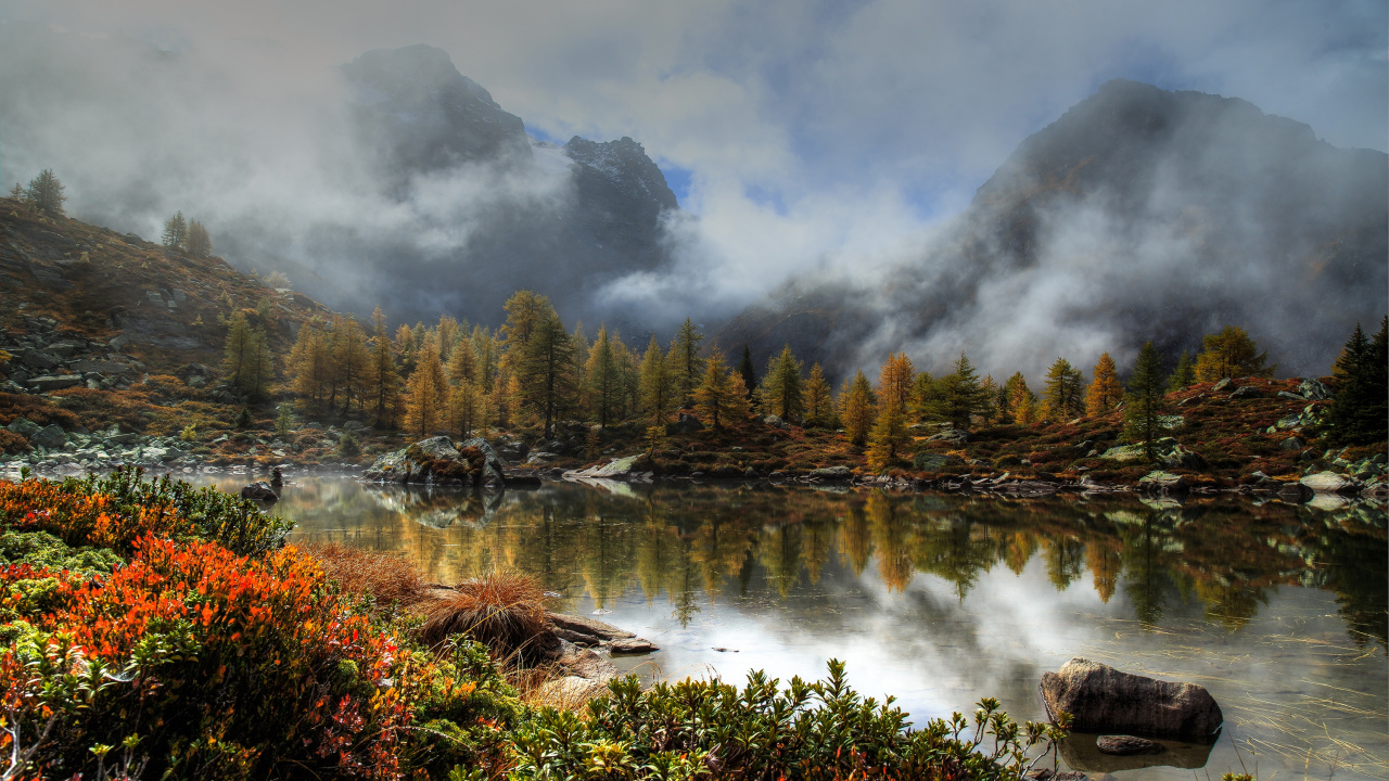 Green Trees Near Lake Under Cloudy Sky During Daytime. Wallpaper in 1280x720 Resolution