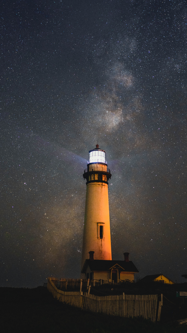 White and Black Light House Under Starry Night. Wallpaper in 750x1334 Resolution