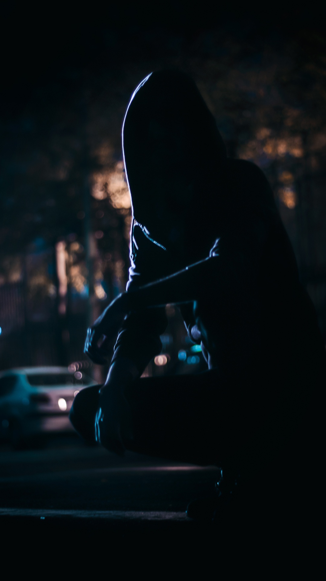Silhouette of Person Sitting on The Street During Night Time. Wallpaper in 1080x1920 Resolution