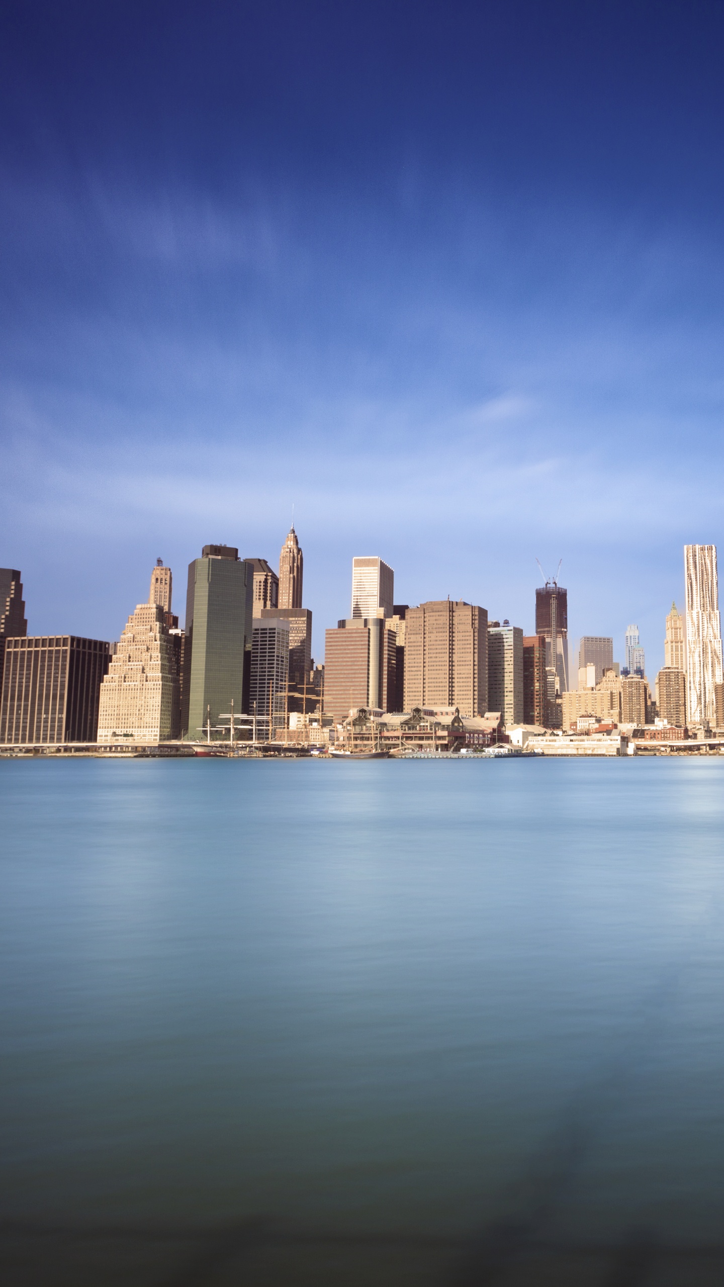 City Skyline Across Body of Water During Daytime. Wallpaper in 1440x2560 Resolution