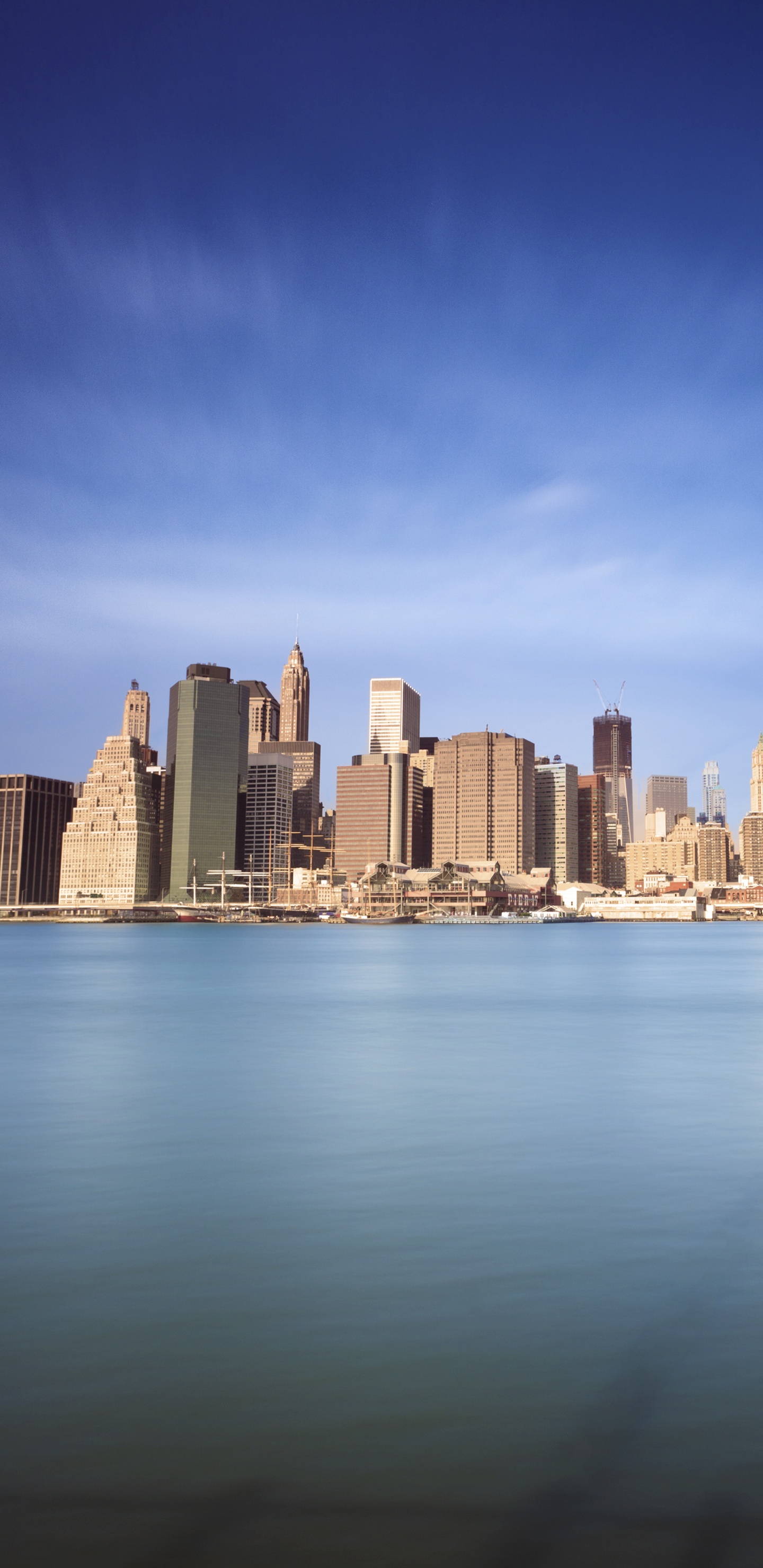 City Skyline Across Body of Water During Daytime. Wallpaper in 1440x2960 Resolution