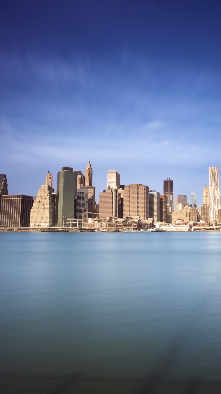 City Skyline Across Body of Water During Daytime. Wallpaper in 720x1280 Resolution