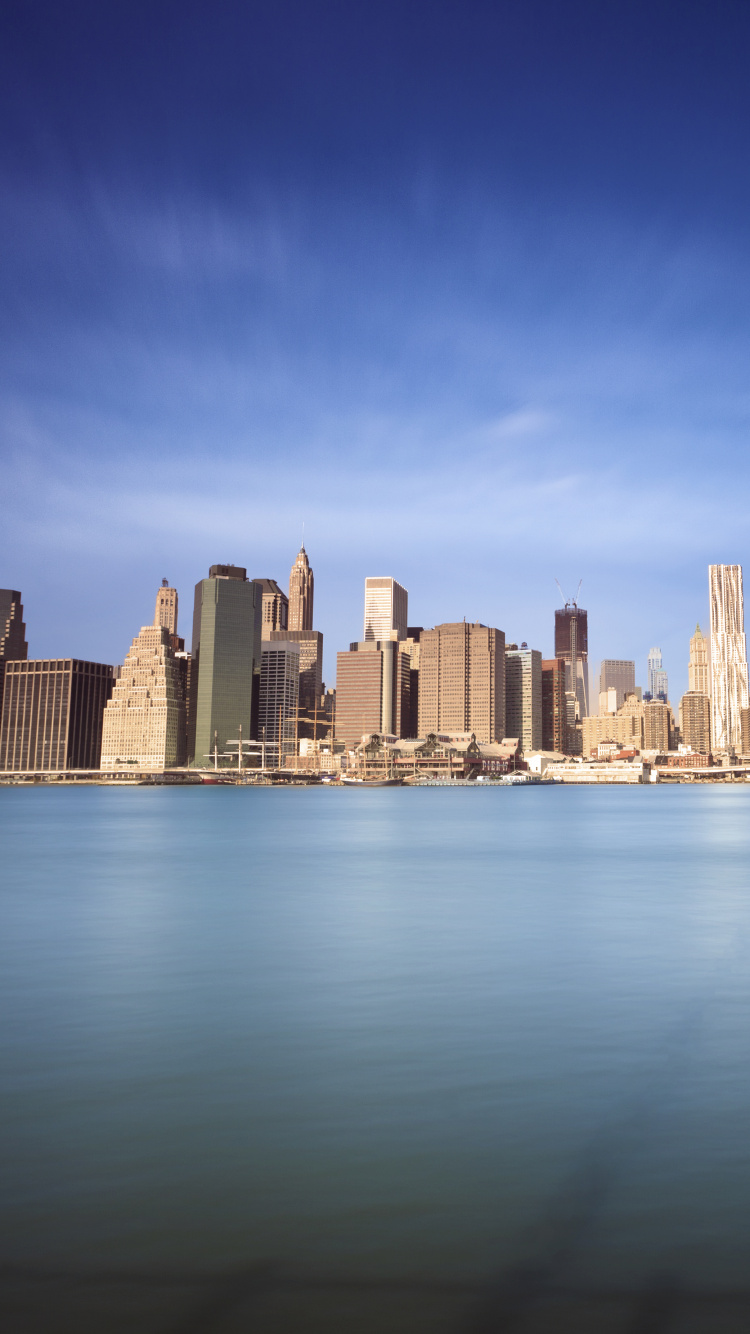 City Skyline Across Body of Water During Daytime. Wallpaper in 750x1334 Resolution