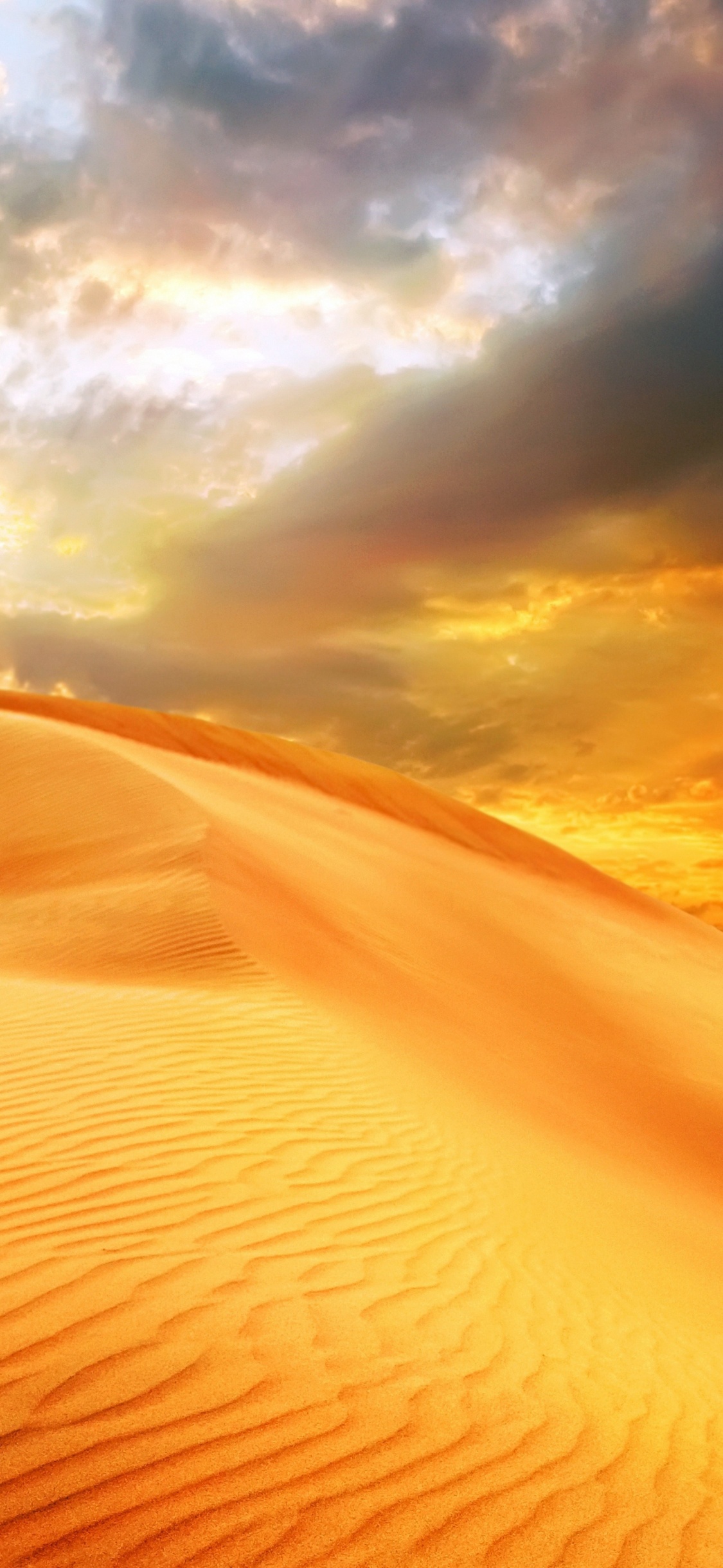 Sable Brun Sous Des Nuages Blancs Pendant la Journée. Wallpaper in 1125x2436 Resolution