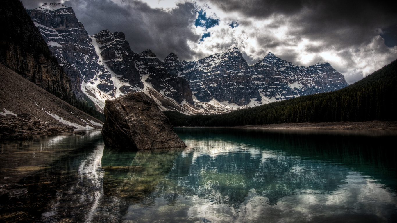 Lake Near Mountain Under Cloudy Sky During Daytime. Wallpaper in 1366x768 Resolution