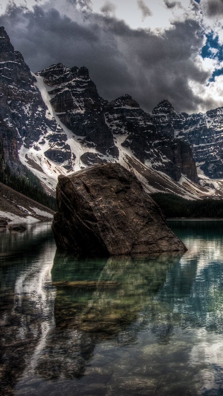 Lake Near Mountain Under Cloudy Sky During Daytime. Wallpaper in 720x1280 Resolution