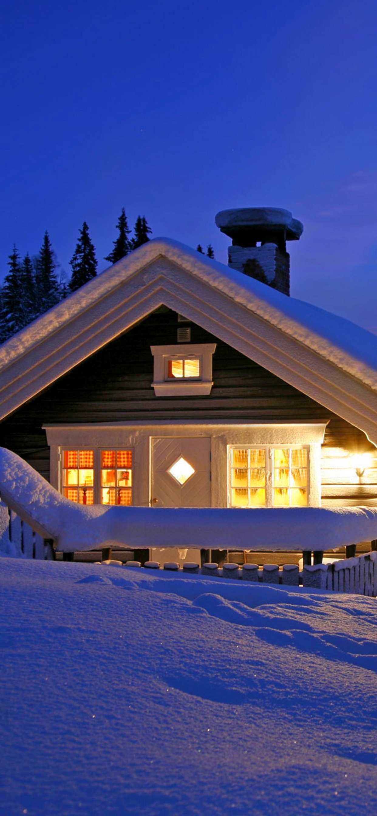 Brown Wooden House Covered With Snow During Night Time. Wallpaper in 1242x2688 Resolution