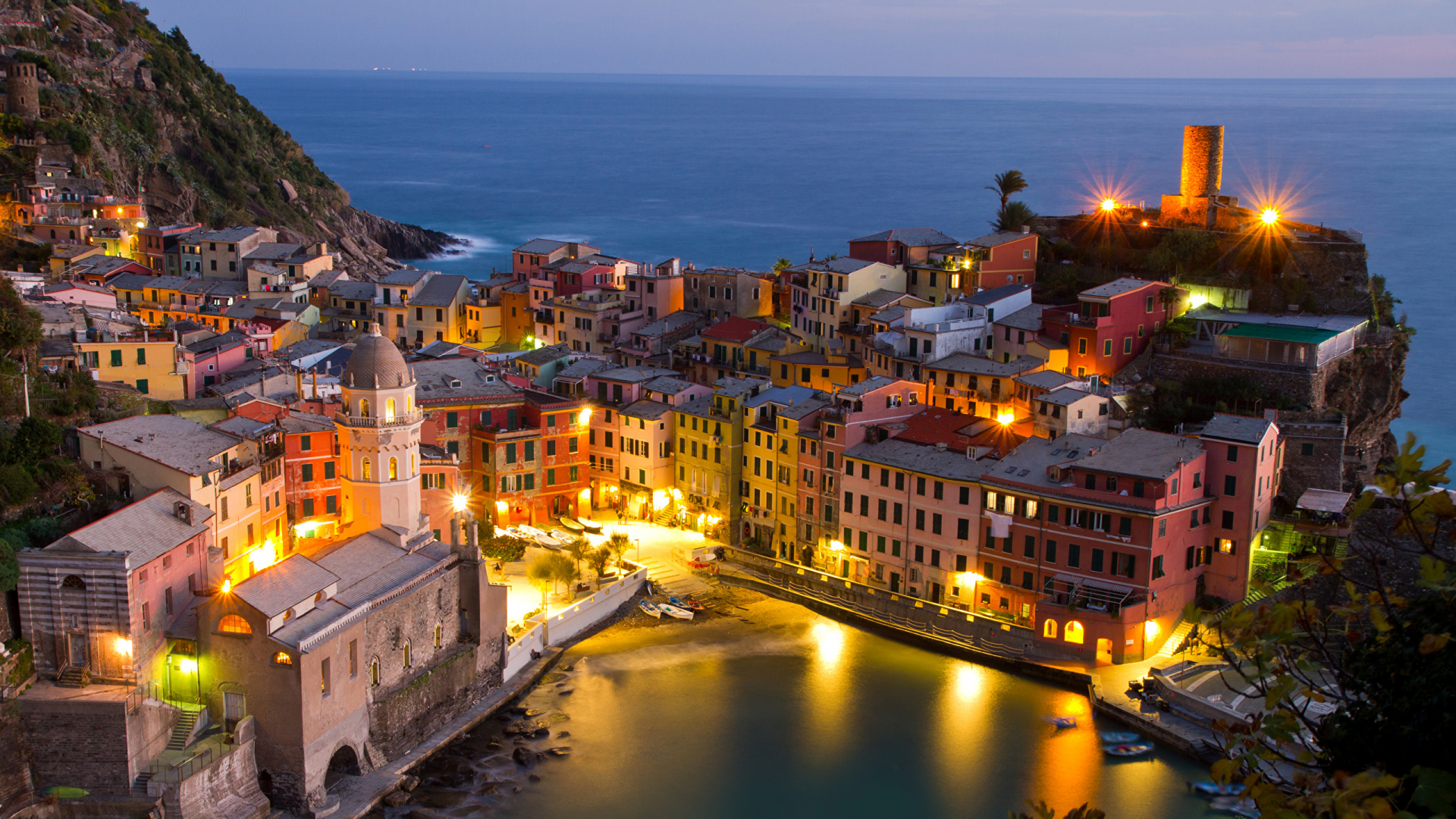 Brown Concrete Building Near Body of Water During Night Time. Wallpaper in 1920x1080 Resolution