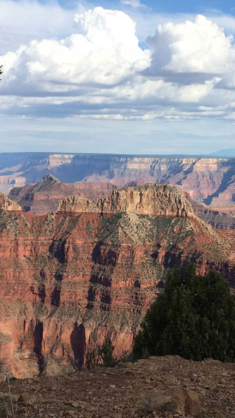 Brown Rocky Mountain Under White Clouds During Daytime. Wallpaper in 750x1334 Resolution