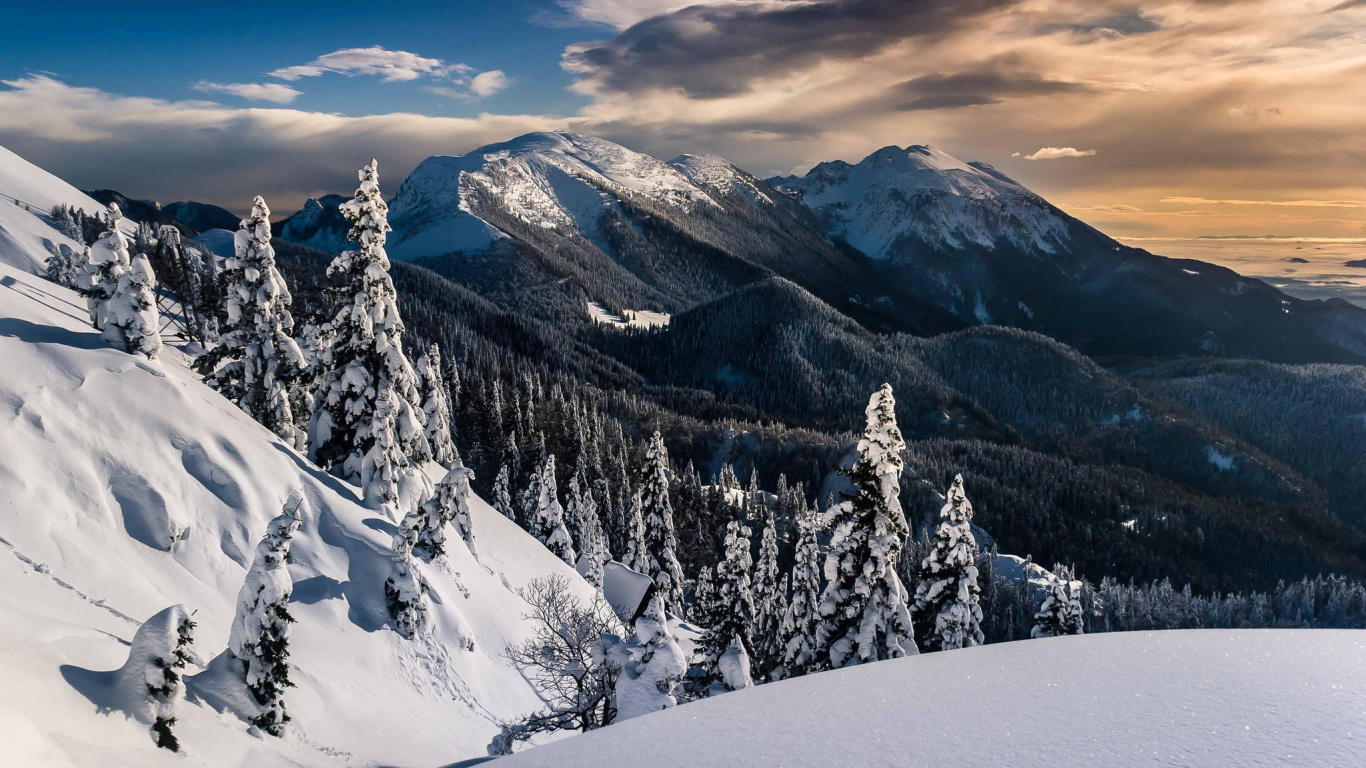 Snow Covered Mountain Under Cloudy Sky During Daytime. Wallpaper in 1366x768 Resolution