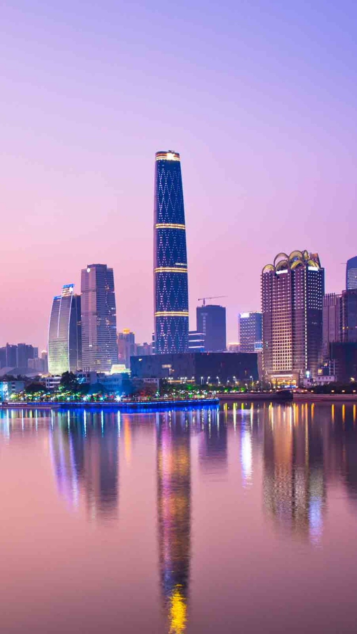 City Skyline Across Body of Water During Night Time. Wallpaper in 720x1280 Resolution