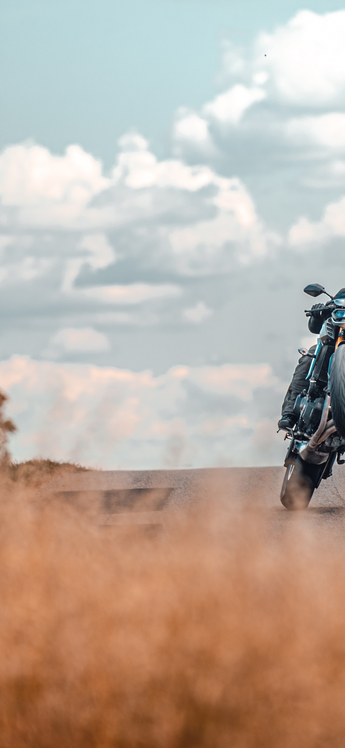 Man in Black Jacket Riding Motorcycle on Road During Daytime. Wallpaper in 1125x2436 Resolution