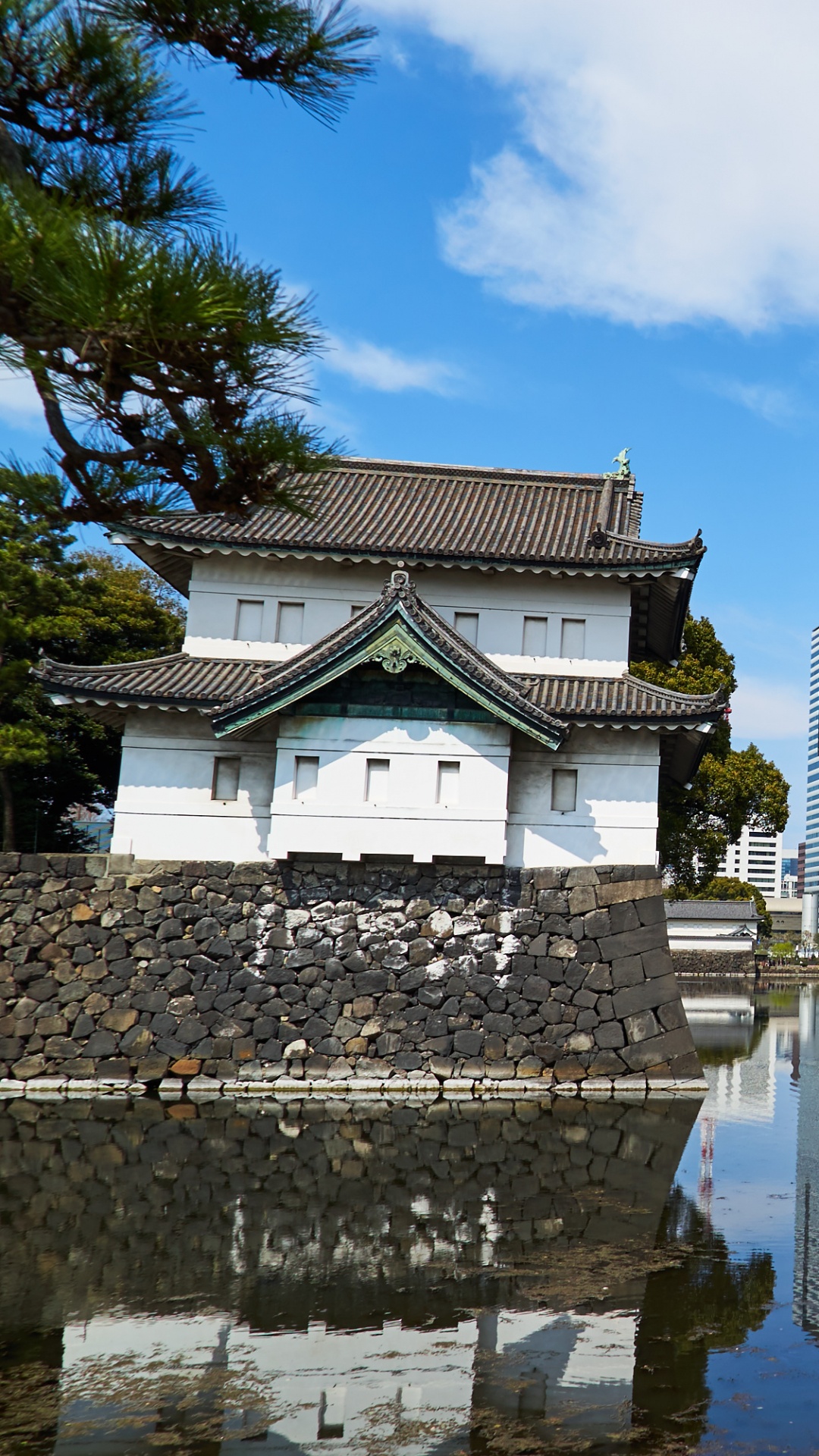 White Concrete Building Near Body of Water During Daytime. Wallpaper in 1080x1920 Resolution