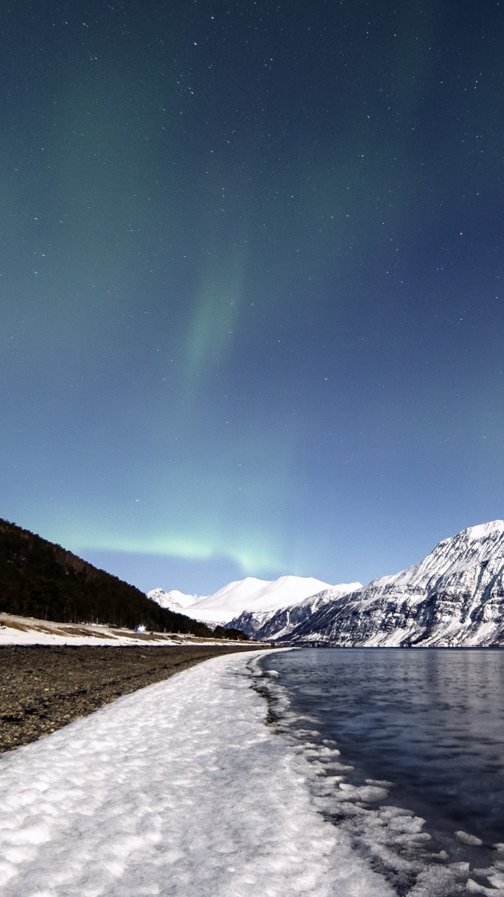 Snow Covered Mountain Near Body of Water During Night Time. Wallpaper in 720x1280 Resolution