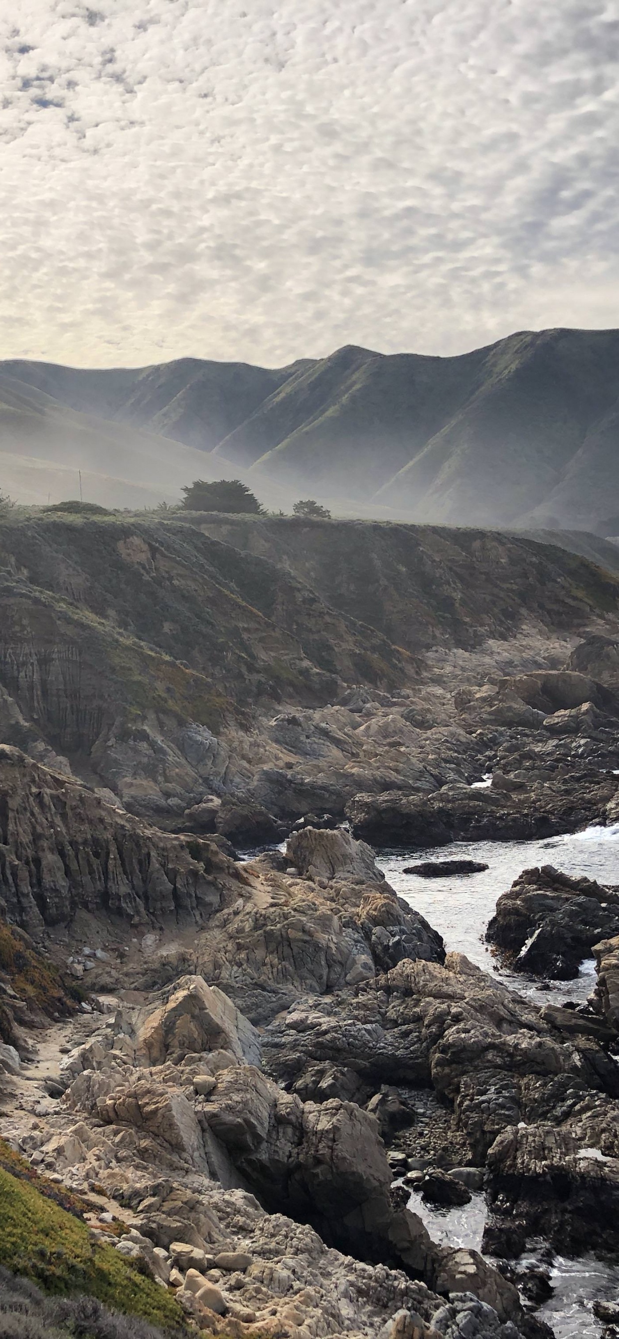 Green and Brown Mountain Under White Sky During Daytime. Wallpaper in 1242x2688 Resolution