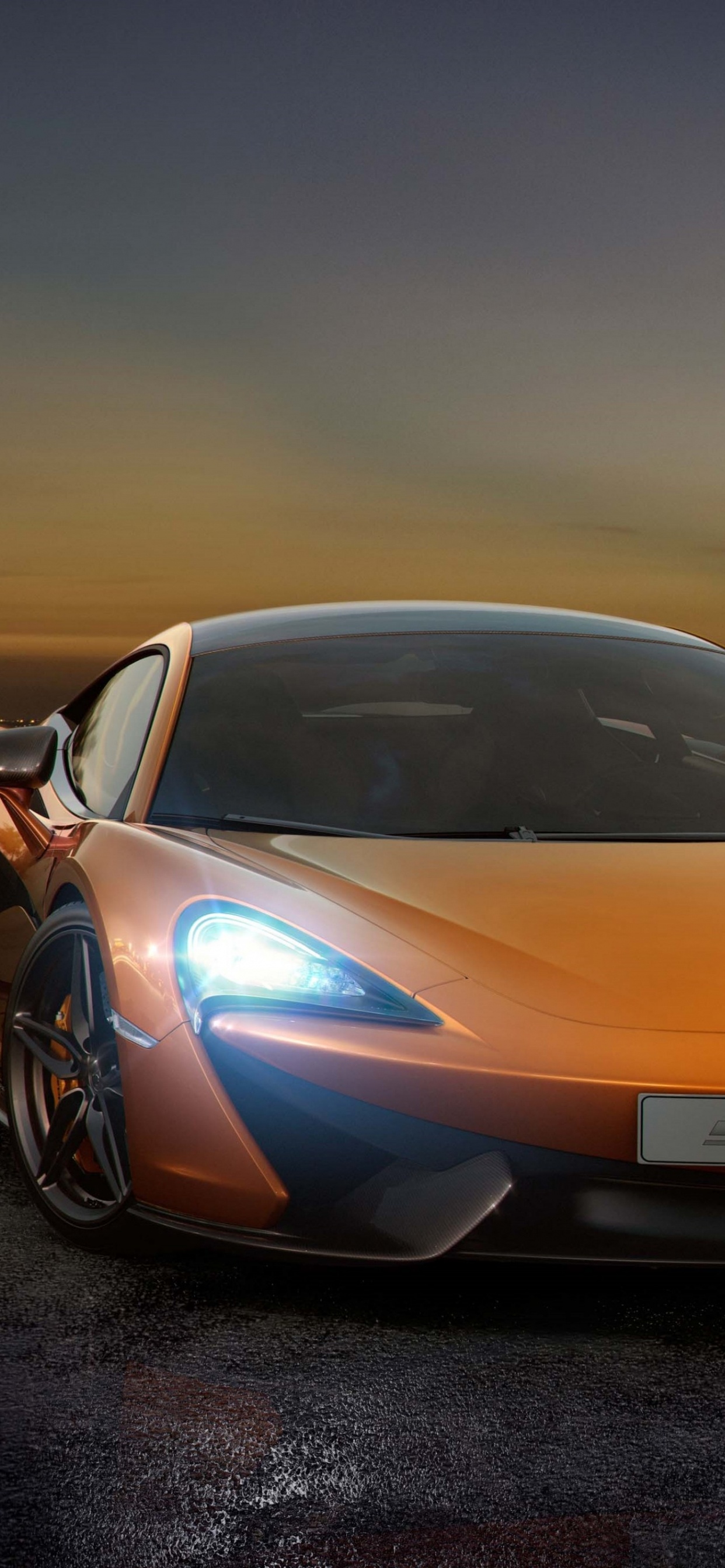 Orange Lamborghini Aventador on Black Sand During Sunset. Wallpaper in 1242x2688 Resolution