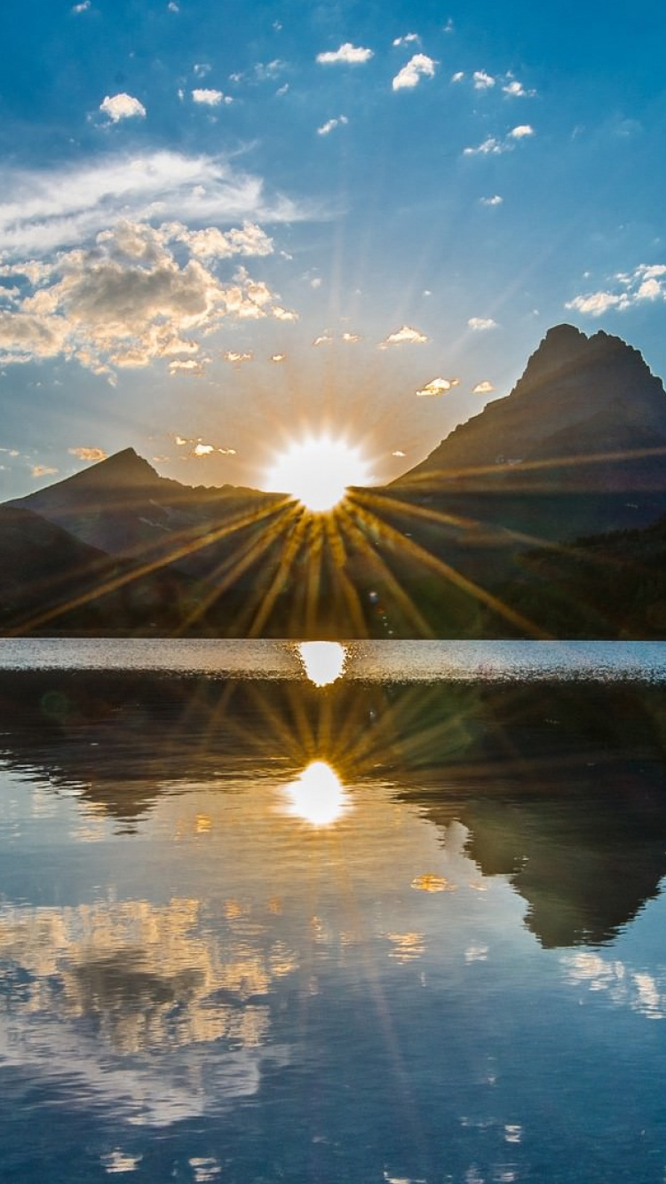 Body of Water Near Mountain Under Blue Sky During Daytime. Wallpaper in 750x1334 Resolution
