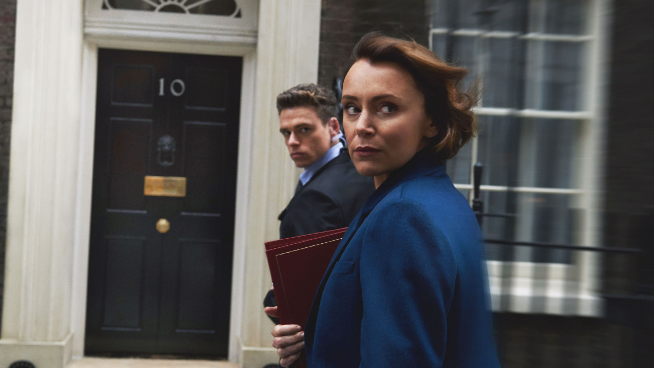 Man in Blue Sweater Standing Beside Woman in Black Coat. Wallpaper in 1280x720 Resolution