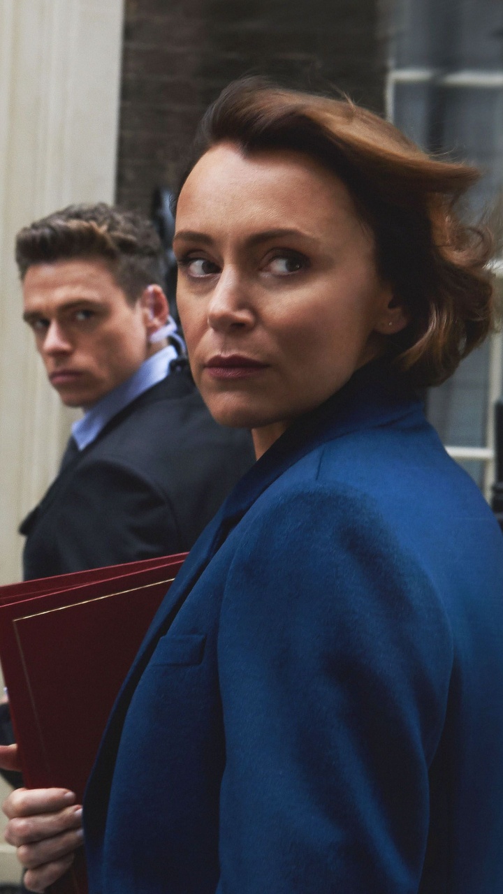 Man in Blue Sweater Standing Beside Woman in Black Coat. Wallpaper in 720x1280 Resolution