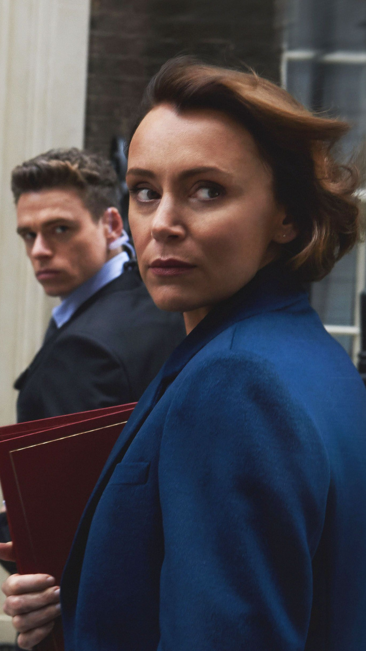 Man in Blue Sweater Standing Beside Woman in Black Coat. Wallpaper in 750x1334 Resolution