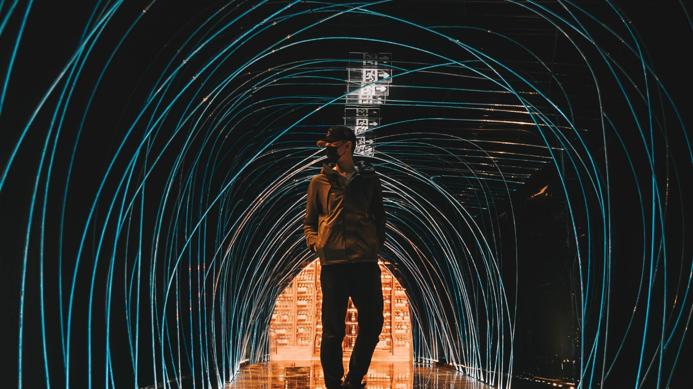 Man in Black Jacket Standing in Tunnel. Wallpaper in 1366x768 Resolution