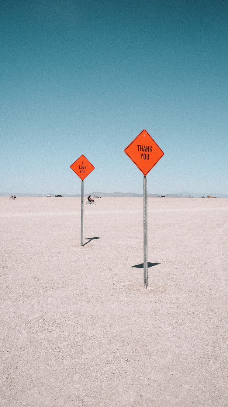 Red and White Stop Sign on White Sand During Daytime. Wallpaper in 750x1334 Resolution