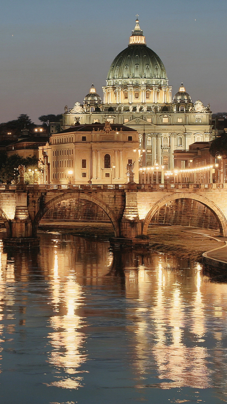 White Concrete Building Near Body of Water During Night Time. Wallpaper in 750x1334 Resolution