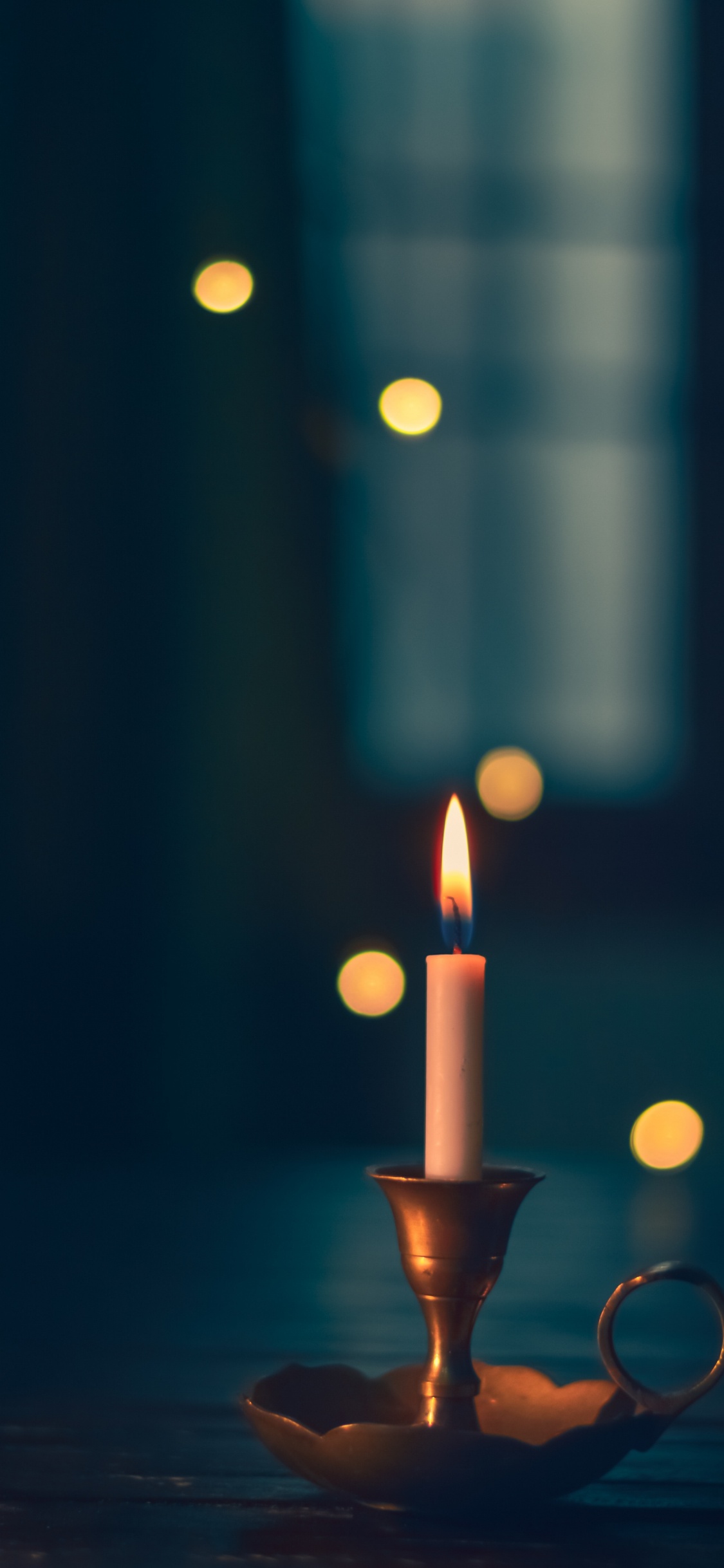 Lighted Candle in Black Holder. Wallpaper in 1125x2436 Resolution