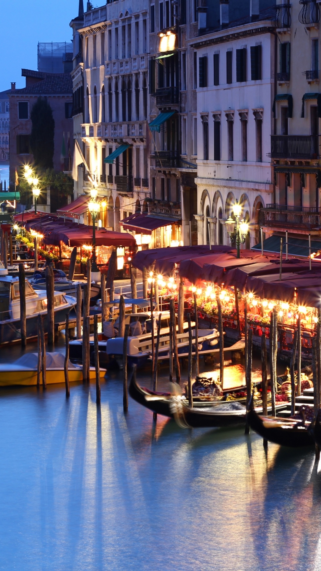 People Riding on Boat on River Near Buildings During Night Time. Wallpaper in 1080x1920 Resolution