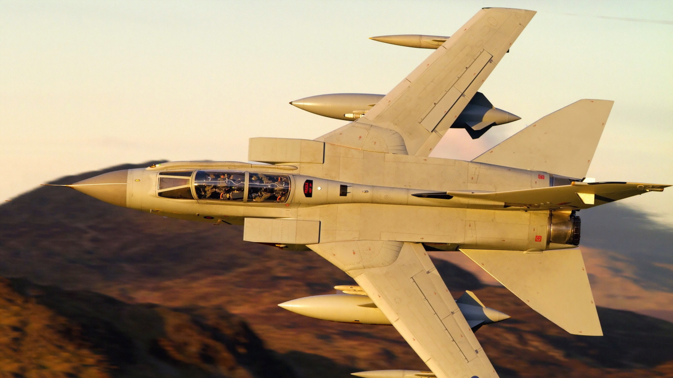 Gray Fighter Jet Flying Over Brown Field During Daytime. Wallpaper in 1366x768 Resolution