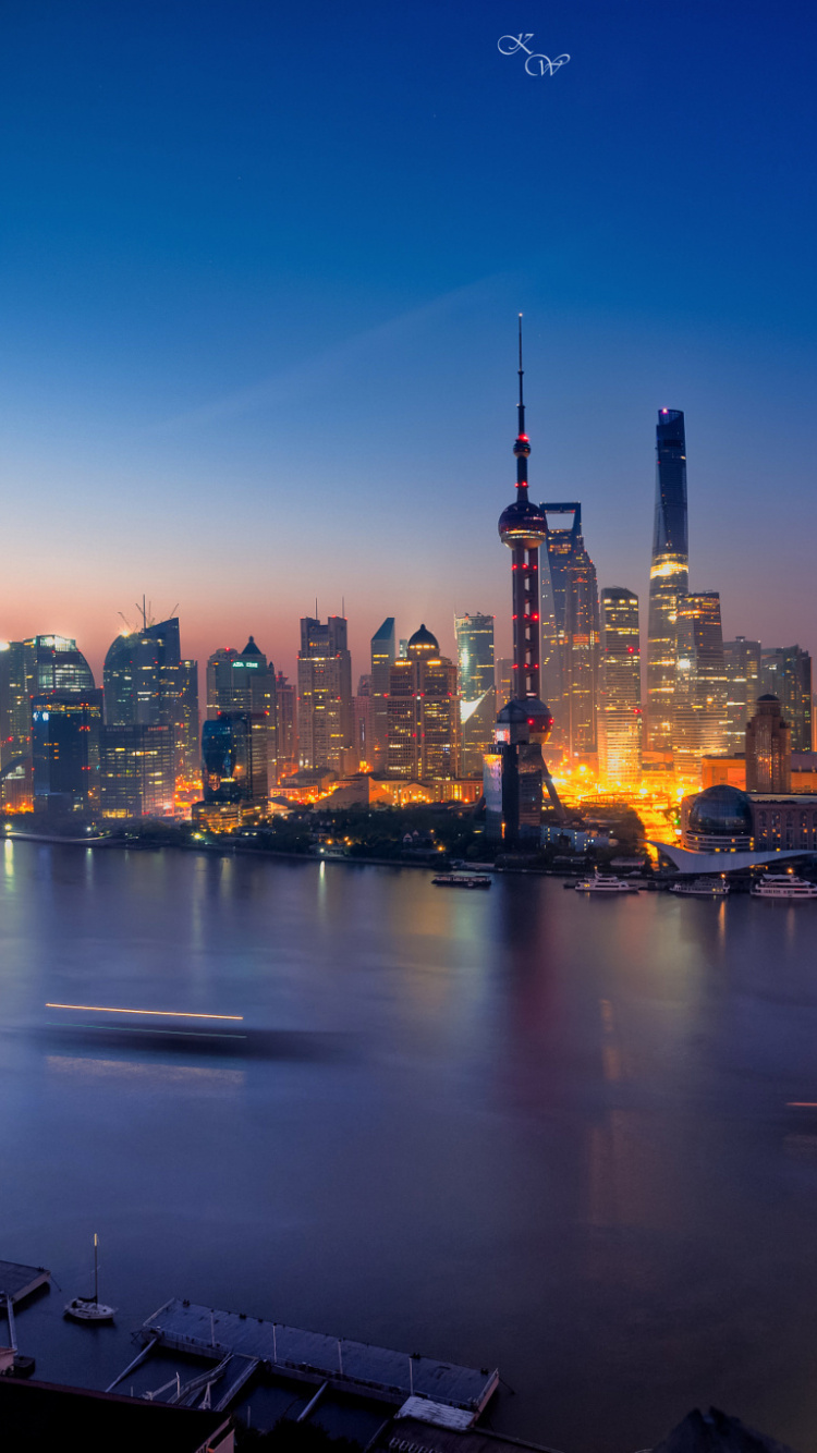 City Skyline Across Body of Water During Night Time. Wallpaper in 750x1334 Resolution