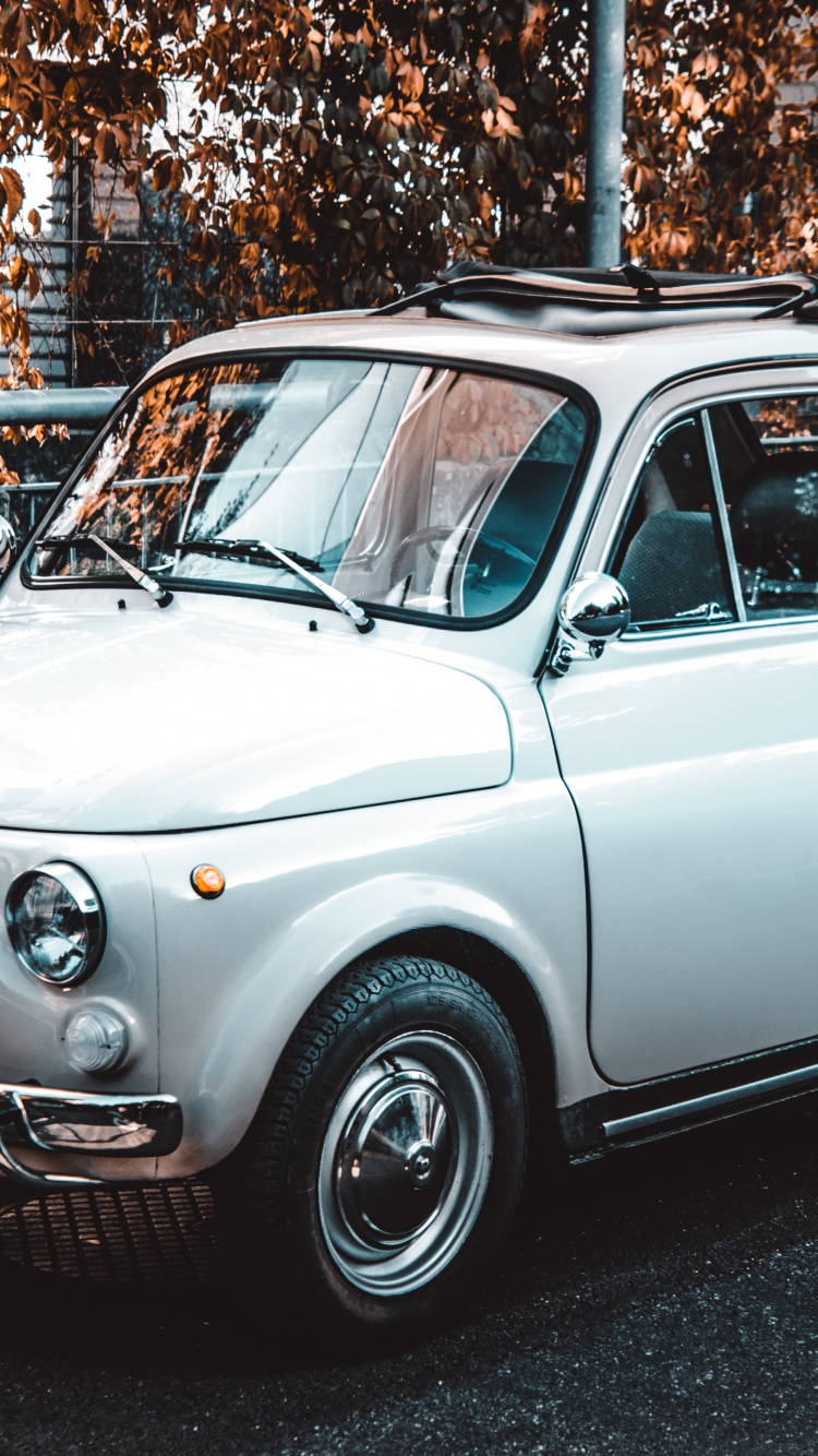 White Classic Car Parked on The Side of The Road. Wallpaper in 750x1334 Resolution